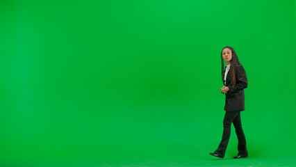 Young female reporter isolated on chroma key green screen background. Full shot african american...