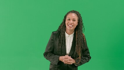 Young female reporter isolated on chroma key green screen background. African american woman tv...
