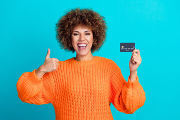 Photo of attractive cheerful person hold debit card demonstrate thumb up approval isolated on...