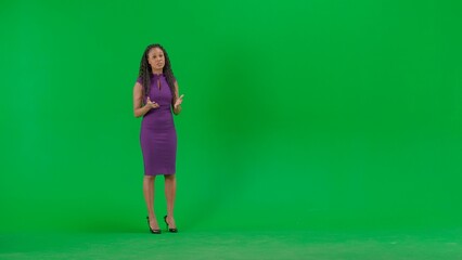 Female in dress isolated on chroma key green screen background. Full shot african american woman tv...