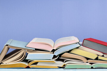 Open book, hardback colorful books on wooden table. Back to school. Copy space for text. Education business concept.