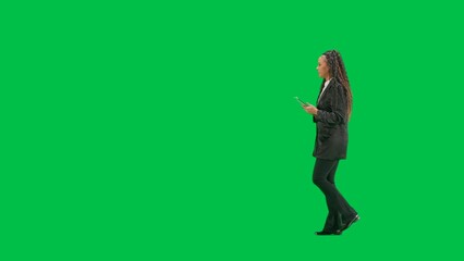 Young female reporter isolated on chroma key green screen background. Full shot african american...