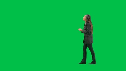 Young female reporter isolated on chroma key green screen background. Full shot african american...