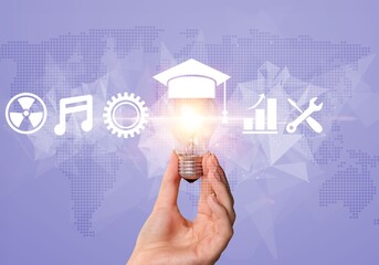The concept of modern e-learning education, hand with lamp