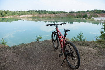 Fototapeta premium panoramic view of lake, bicycle in foreground