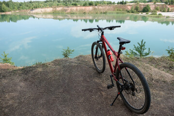Fototapeta premium panoramic view of lake, bicycle in foreground
