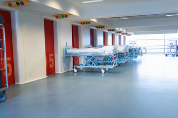 Clean hospital beds covered with film, ready for new patients.