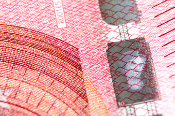 Close-up of a 10 euro banknote fragment with the portrait hologram. Macro photography.