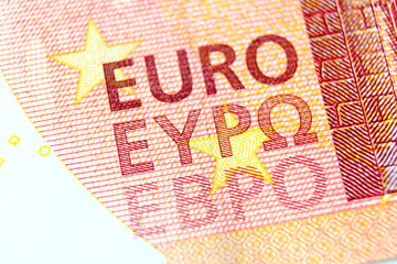 Close-up of a 10 euro banknote fragment with the name of the currency EURO. Macro photography.
