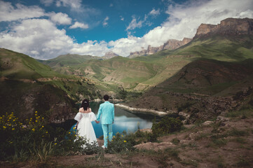 wedding couple at destination. Mountains and lake view. A picturesque place for a wedding