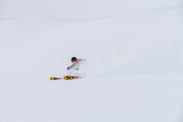 Male skier turns in loose snow, skier downhill downhill at ski resort