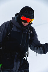 Portrait of a skier in safe ski equipment, standing and relaxing smiling while on vacation on the ski slope