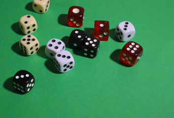 on a green background there are many dice of different colors and sizes