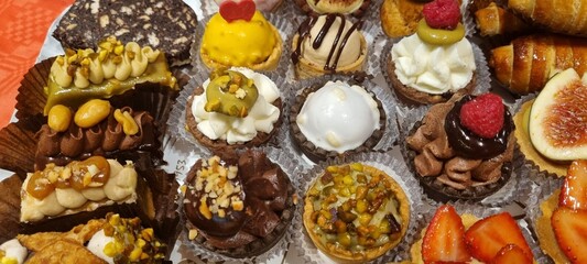 Close-up of a delectable selection of mini tarts and pastries, perfect for dessert buffets