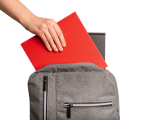 Hand putting books, textbooks into backpack, schoolbag isolated on white background