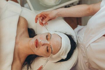 A girl at a cosmetologist does cosmetic procedures. Skin cleansing