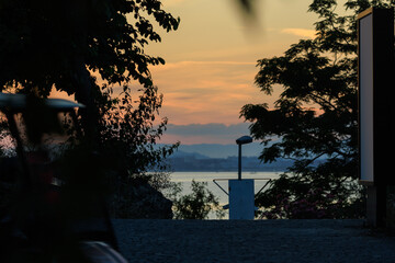 Evening view of the city. Sunset orange sky and beautiful landscape, houses and city streets,...