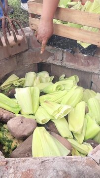 Video of unknown people doing pachamanca. Concept of food preparation.