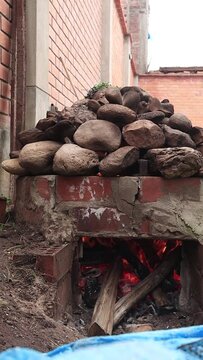 Video of a pachamanca oven with fire inside. 