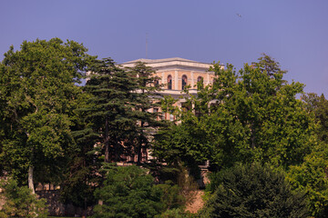 Naklejka premium Beautiful houses and city streets of the southern city with green plants, public place in Turkey, on a summer sunny day