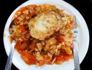 Chop suey is a dish from American Chinese cuisine consisting of stir-fried noodles, meat and eggs, cooked quickly with vegetables and bound in a starch-thickened sauce. 