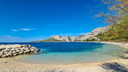 Idyllic sand beach Plaza Brzet in coastal town Omis, Split-Dalmatia, Croatia, Europe. Scenic view...