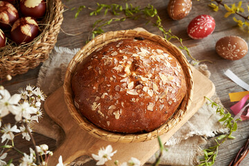 A loaf of Czech sweet Easter pastry called mazanec, with eggs dyed with onion peels and decorated ...