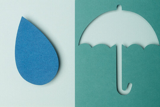 Paper cut out of umbrella and water drop flat