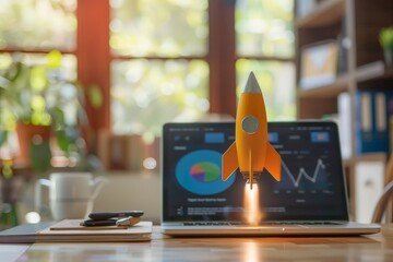 Rocket taking off from laptop on office desk, startup concept