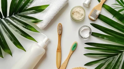 Foto op Plexiglas Eco-conscious bathroom essentials with green tropical leaves on a white background. Sustainable toiletries and skincare flat lay © ANStudio