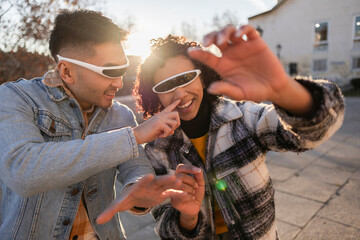 Young Couple Playing with Futuristic VR Glasses Outdoors