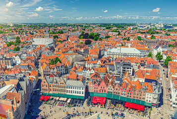 Aerial view of Bruges historical city centre with Market square, old buildings, traditional colourful townhouses, skyline horizon with blue sky, panorama of Brugge old town, West Flanders, Belgium