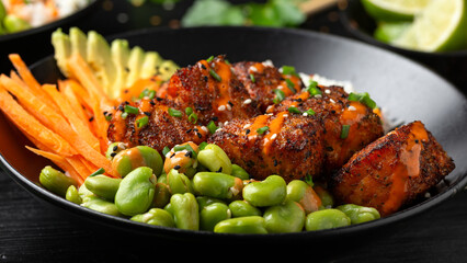Firecracker salmon poke bowl with edamame, avocado carrot and rice