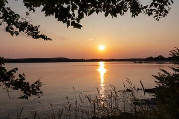Silhouette of tree branch at romantic sunset overlooking idyllic Kvarner Bay in Medulin, Croatia,...