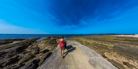 Loving mother walking with baby stroller along coastal road in Medulin, Istria peninsula, Croatia, Europe. Idyllic coastline of Kvarner Gulf in Adriatic Mediterranean Sea. Travel destination in summer