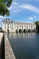 a large white country mansion with normandy style turrets, Chateau de Chenonceau Castle, France