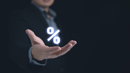 A man hand with palm up is holding the glowing percent sign. Concept of a business sale growth percentage, investment profit rate or discount.