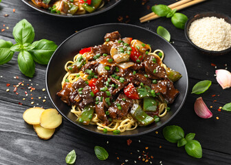 Stir fried beef in black bean sauce with vegetables and noodles. Take away food