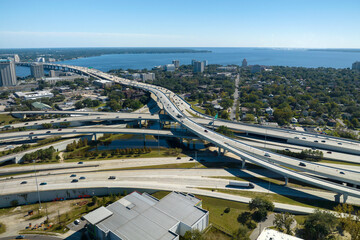 Aerial view of freeway overpass junction with fast moving traffic cars and trucks. Interstate...
