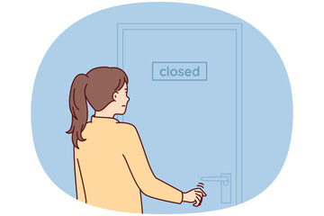 Indecisive woman pulls hand to door with inscription closed stands with back to screen. Girl is discouraged and does not know what to do after store is closed due to bankruptcy