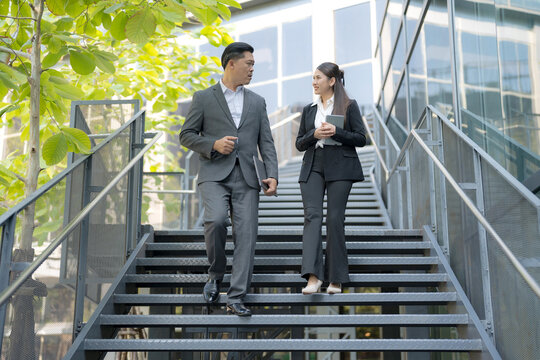 Business colleagues conversing on staircase