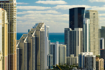 Obraz premium Expensive highrise hotels and condos on Atlantic ocean shore in Sunny Isles Beach city. American tourism infrastructure in southern Florida