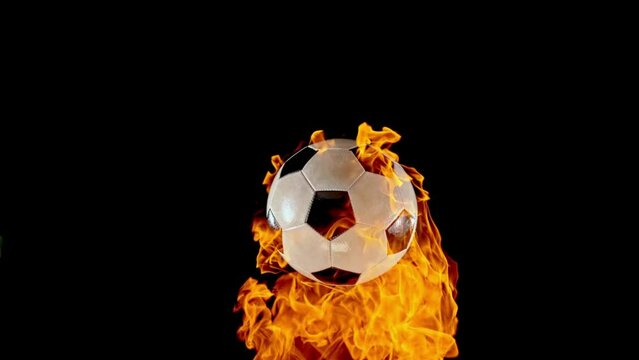 Slow Motion Medium Locked Down Shot of Football Ball Bouncing Off Black Surface and Igniting Fire - Shot in Slovenia - 4K Video