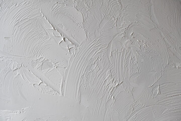 Applying decorative putty. White abstract texture of surface covered with putty. textured...