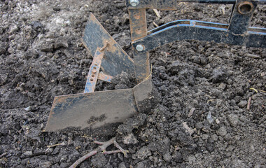 walk-behind tractor plow in the ground. agriculture plowing the land
