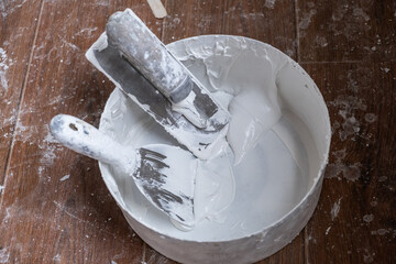 Applying decorative putty. White abstract texture of surface covered with putty. textured...