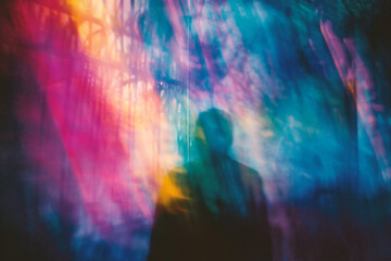 abstract blurred photo of a man walking in the city at night - obrazy, fototapety, plakaty