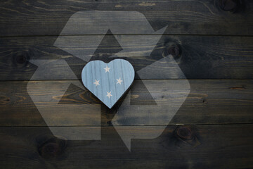 wooden heart with national flag of Federated States of Micronesia near reduce, reuse and recycle sing on the wooden background. concept - obrazy, fototapety, plakaty