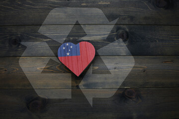 wooden heart with national flag of Samoa near reduce, reuse and recycle sing on the wooden...
