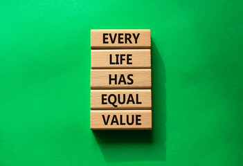Equality symbol. Wooden blocks with words Every Life has Equal Value. Beautiful green background....
